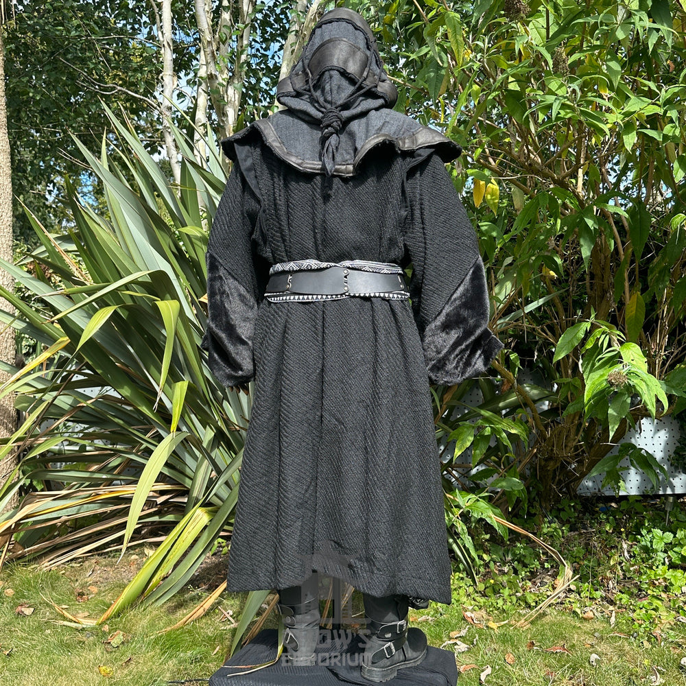 Medieval LARP costume back view, featuring a black robe, hood, arm wraps, belt and sash. For Renaissance Faire and historical roleplay events.