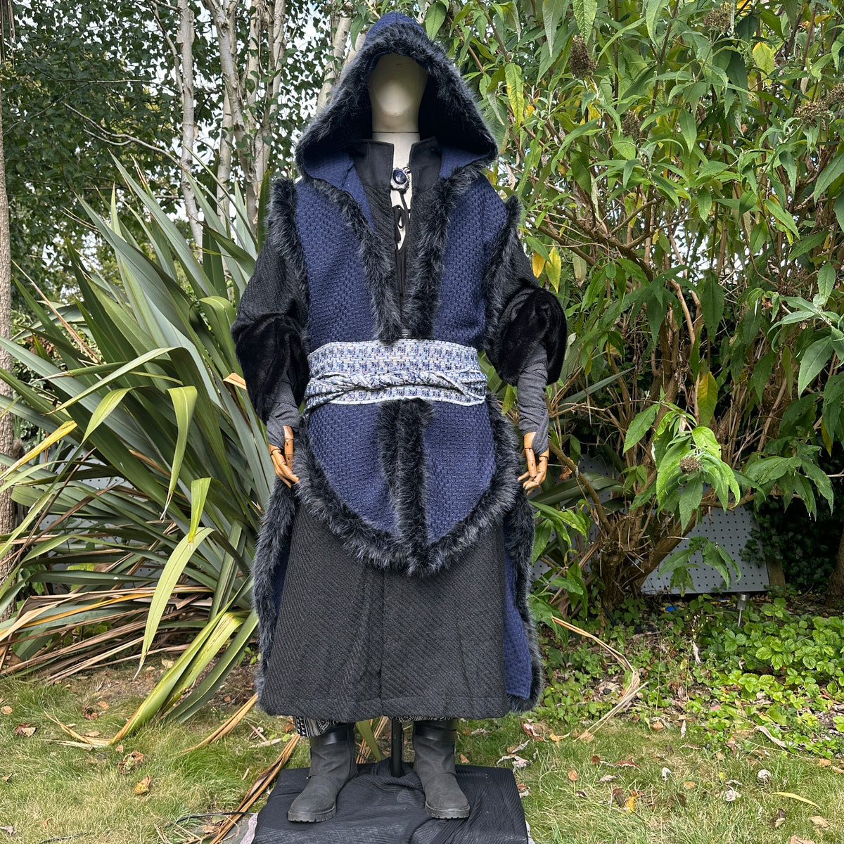 Front view of blue and black fur-trimmed Viking LARP cape with hood, medieval fantasy cosplay.