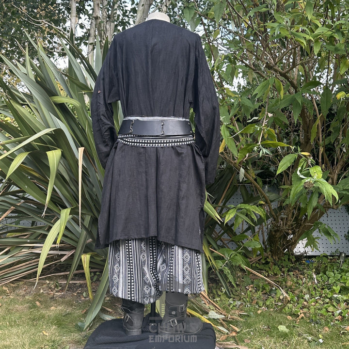 Medieval LARP outfit back view, featuring a black tunic, patterned trousers and sash. For Renaissance Faire and historical roleplay events.