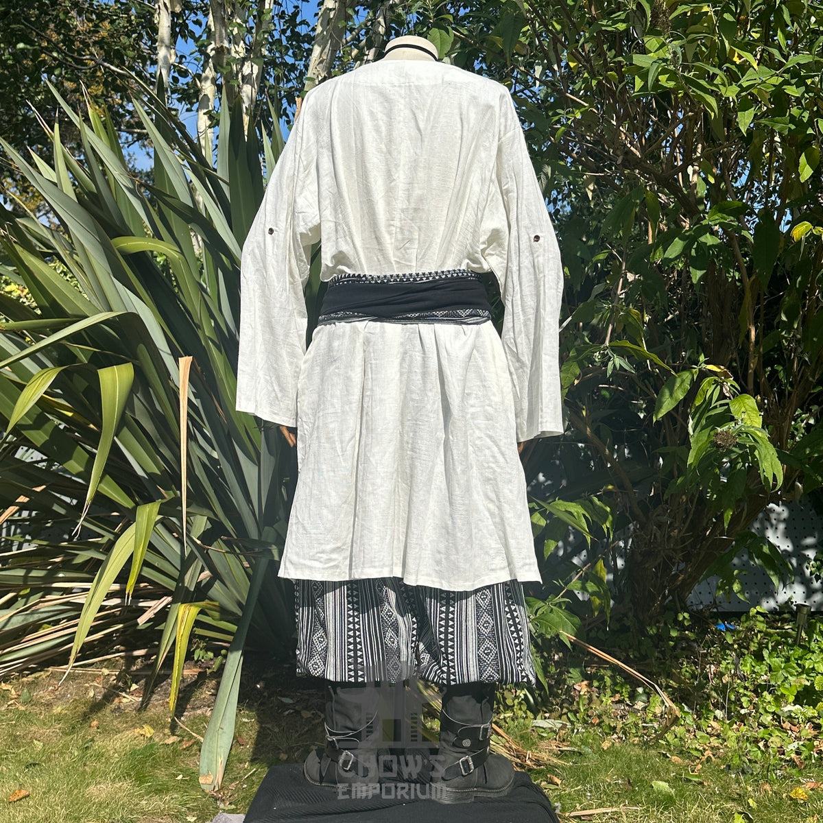 Medieval LARP outfit back view, featuring a white tunic, black and white trousers and matching sash.