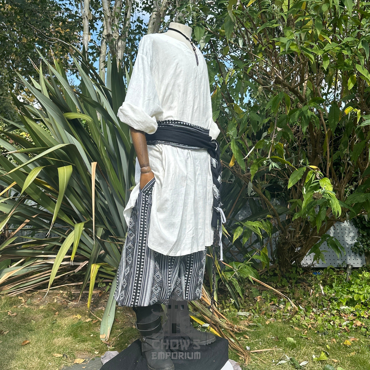 Medieval LARP outfit side view, featuring a grey tunic, trousers, leather belt and sashes.