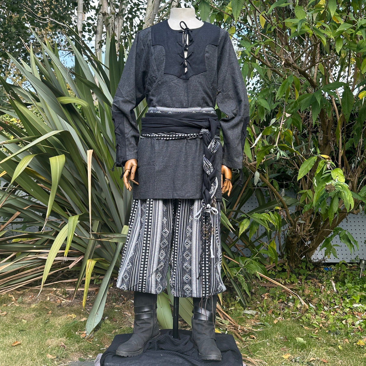 Medieval LARP outfit front view, featuring a grey two-tone shirt, black trousers and sash.