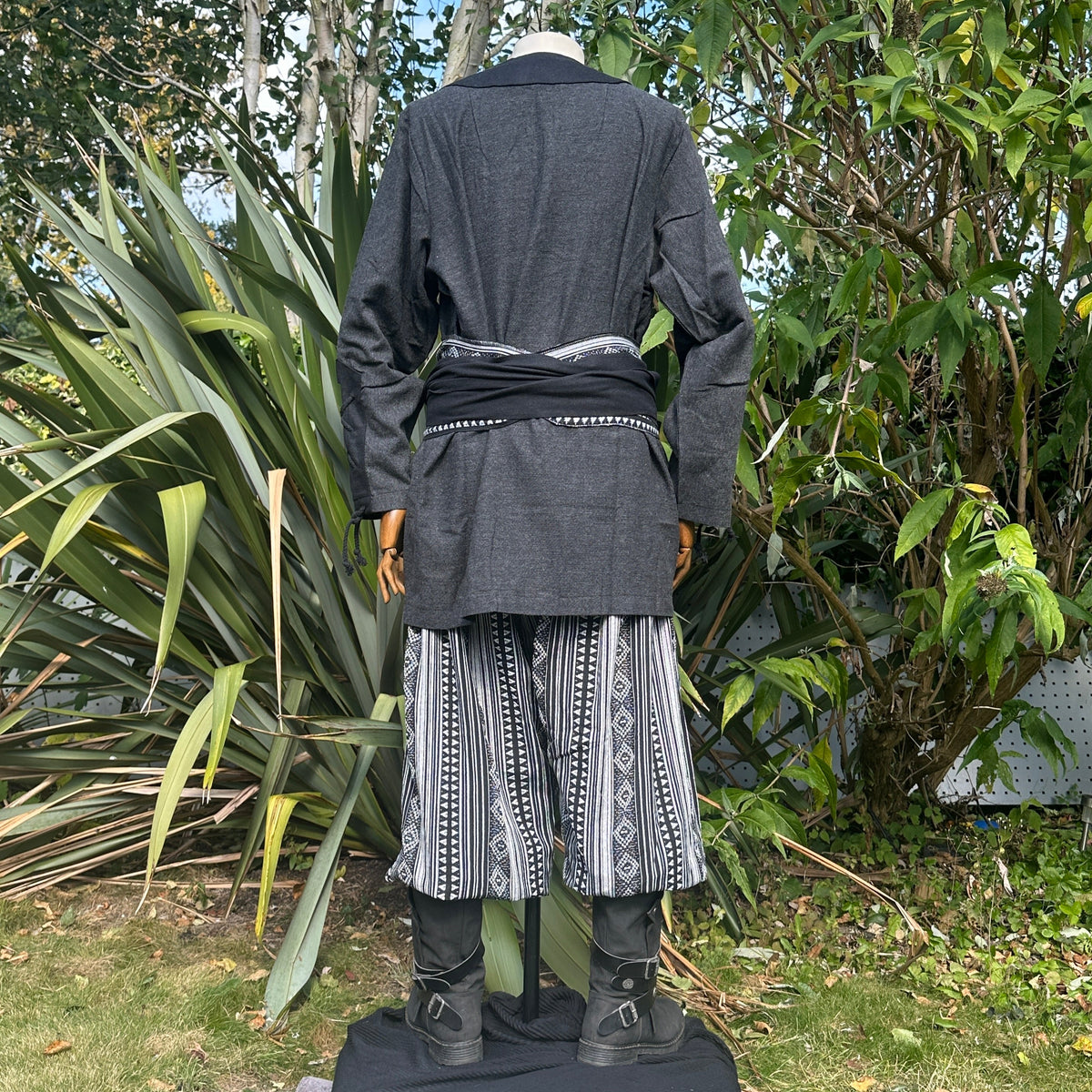 Medieval LARP outfit back view, featuring a grey two-tone shirt, black trousers and sash.