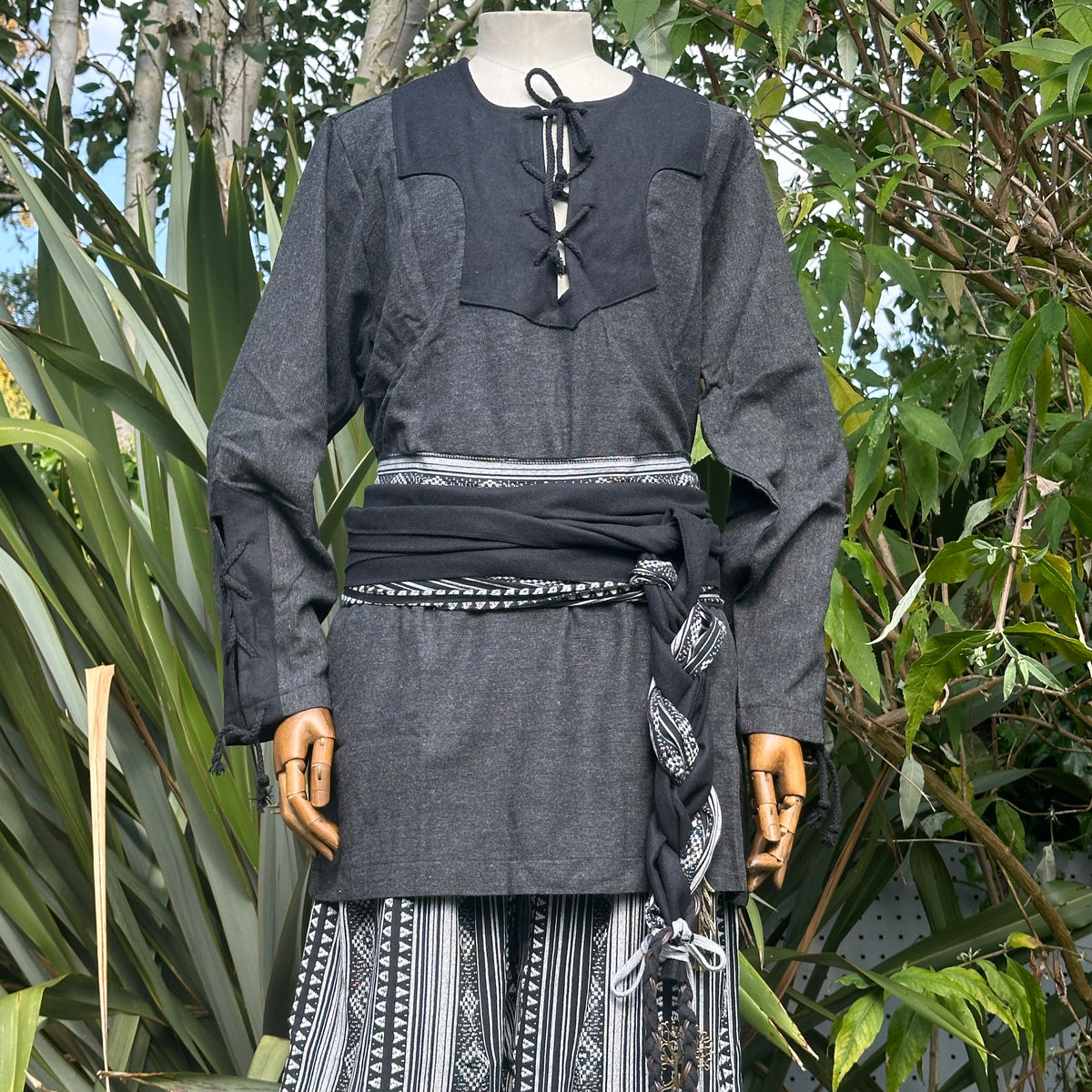 Black and white medieval LARP outfit with shirt, trousers, sash, front view.
