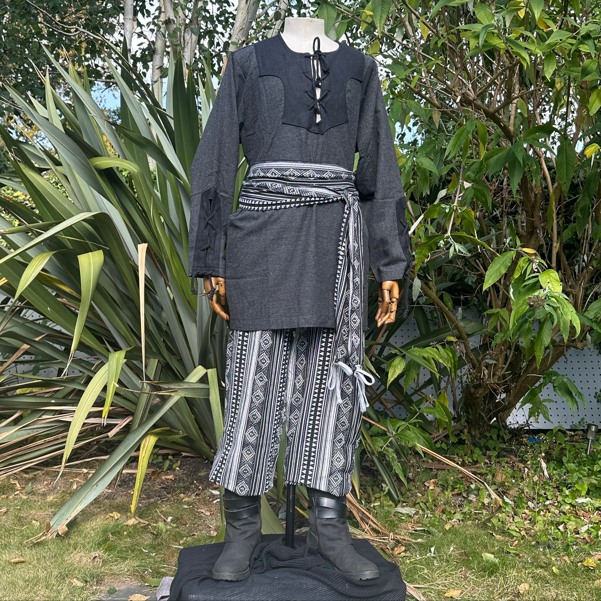 LARP outfit with black shirt, patterned trousers, sash, front view.