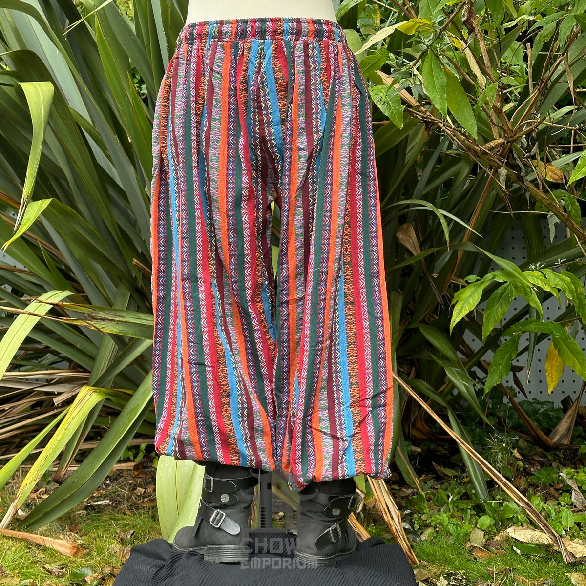 Back view of red multi-stripe cotton LARP pants showing relaxed fit and reinforced seams.