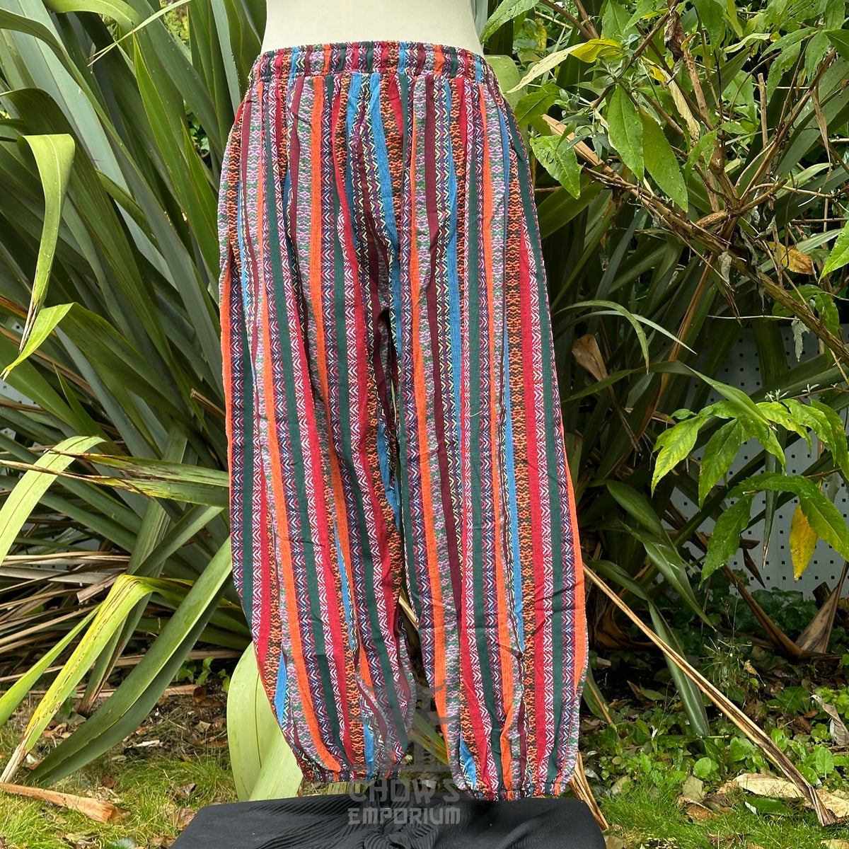 Back view of red multi-stripe cotton LARP pants showing relaxed fit and reinforced seams no boots.