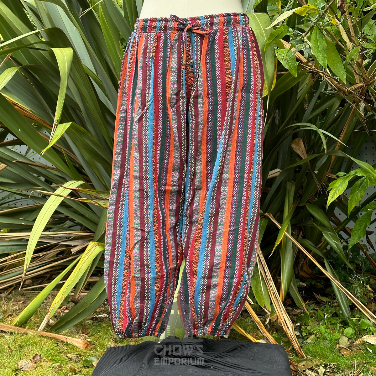 Front view of multi-color medieval hero trousers with elastic waist and ankle cuffs no boots.