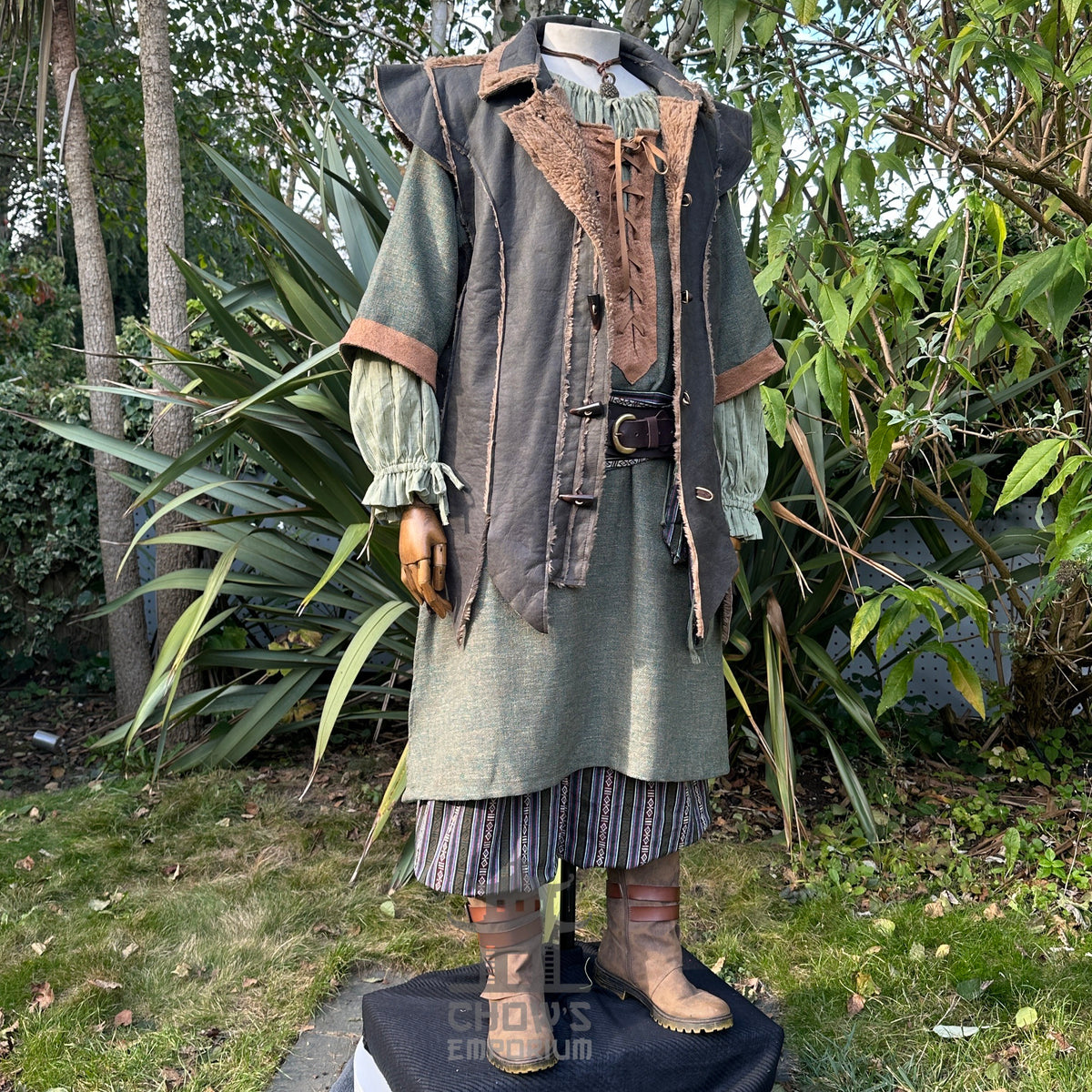 Outdoor photo of medieval fur-trim waistcoat worn with belt and sash for LARP or cosplay.