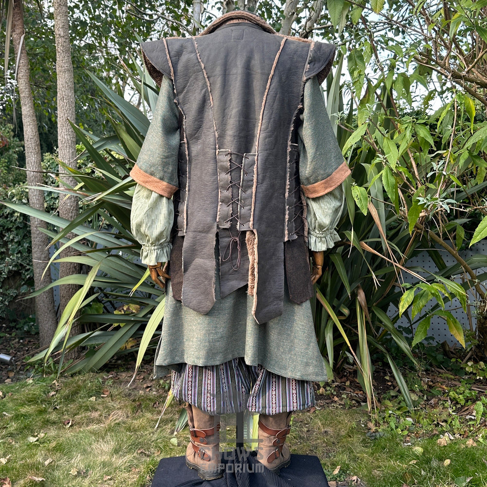 Medieval LARP outfit back view, featuring a green faux leather waistcoat, tunic, trousers and sash. For Renaissance Faire and historical roleplay events