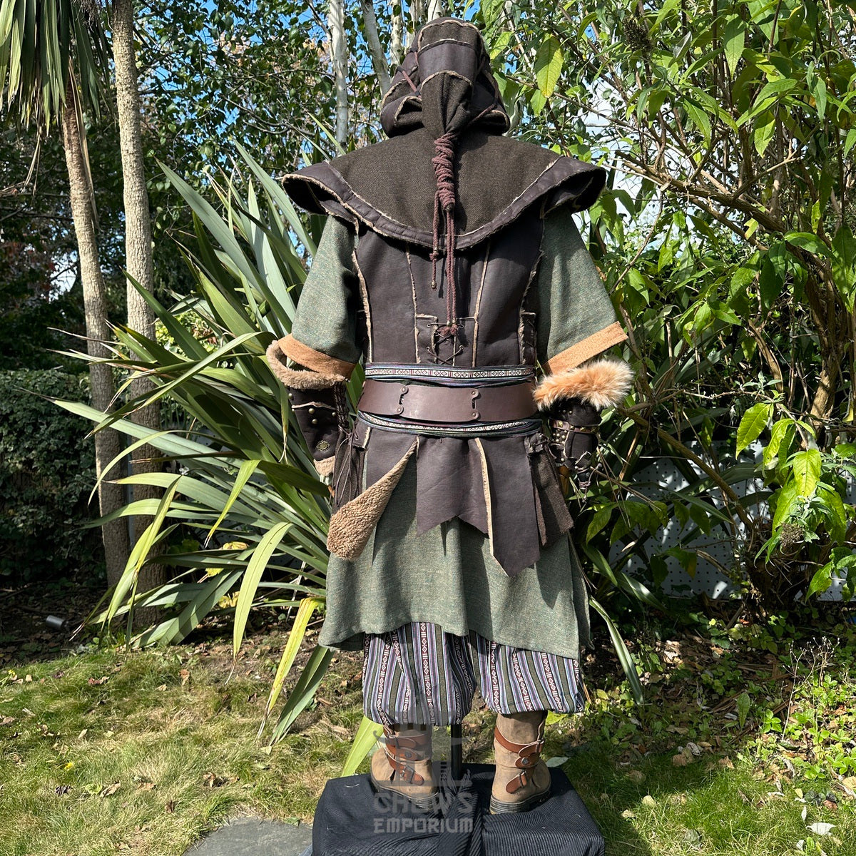 Medieval LARP costume back view, featuring brown leather waistcoat, hood and vambraces, a tunic.