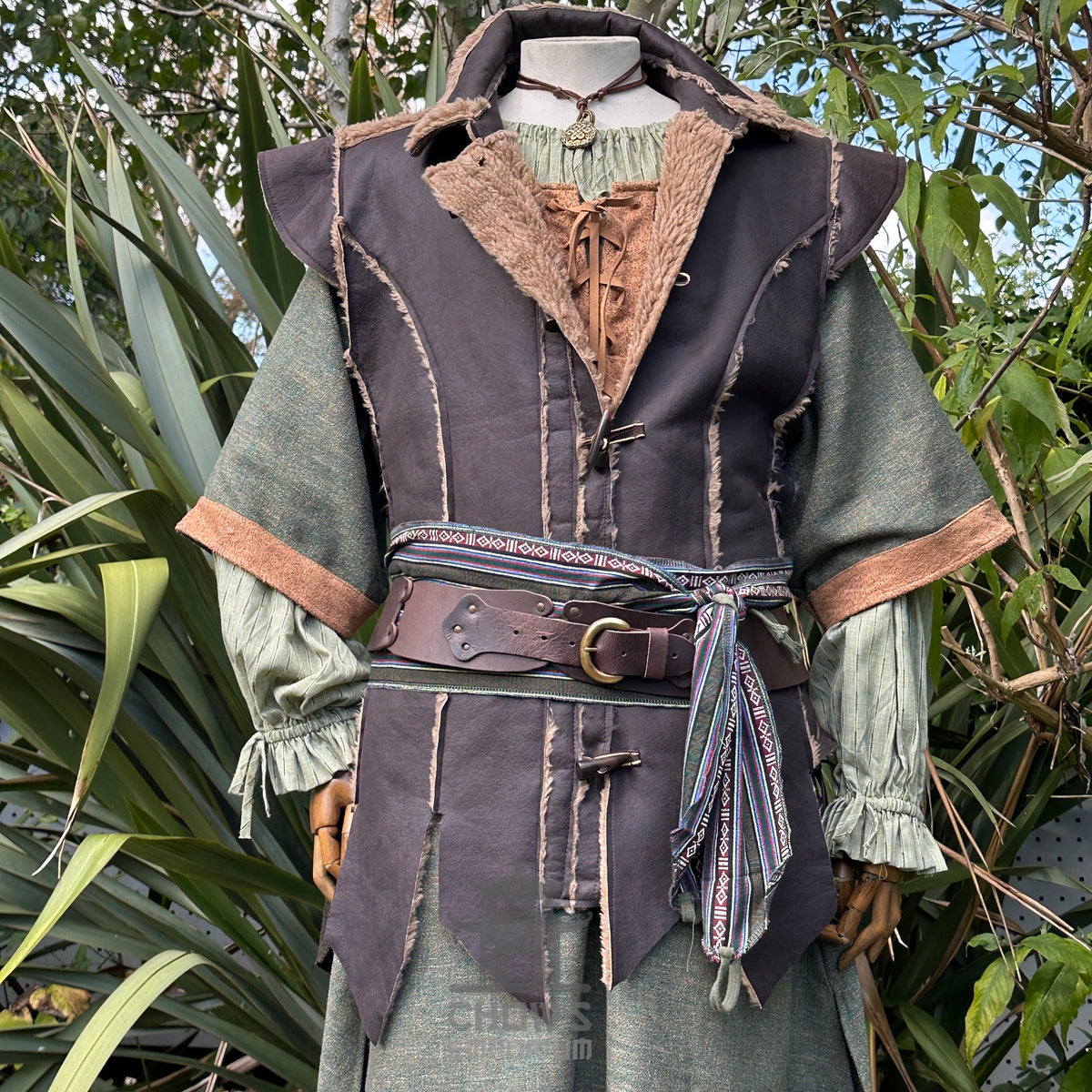 Medieval herbalist LARP outfit with brown waistcoat, green tunic, belt, and sash.