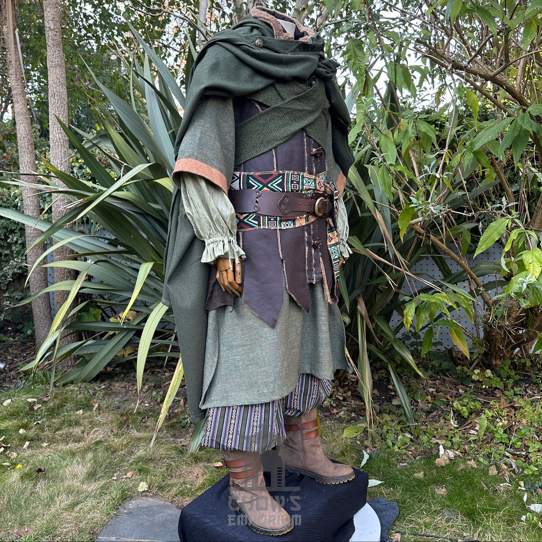 Medieval LARP outfit side view, featuring a green cloak, waistcoat, hood, shirt, trousers, belt and sash. For Renaissance Faire and historical roleplay events.
