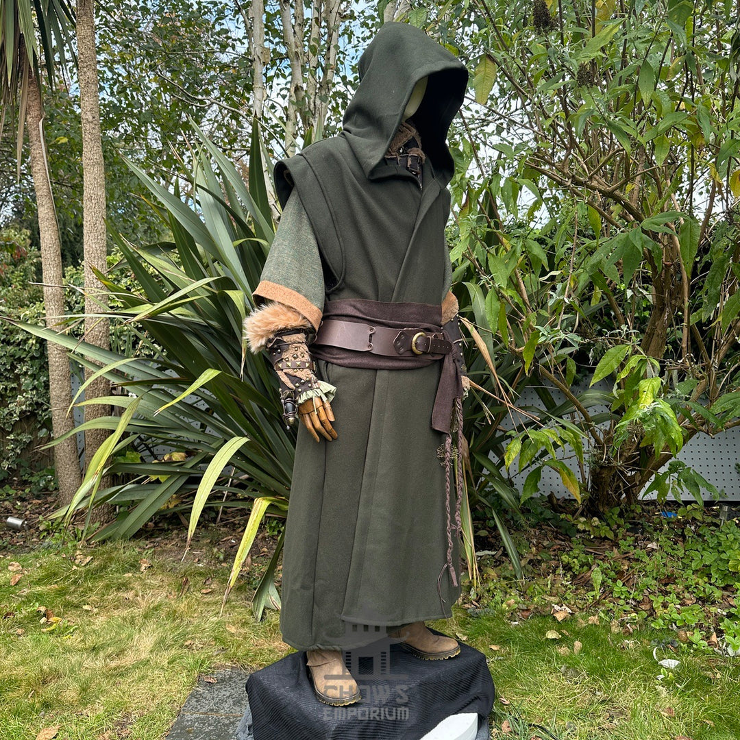 Medieval LARP outfit side view, featuring a green hooded robe, vambraces, belt, and sash. For Renaissance Faire and historical roleplay events.