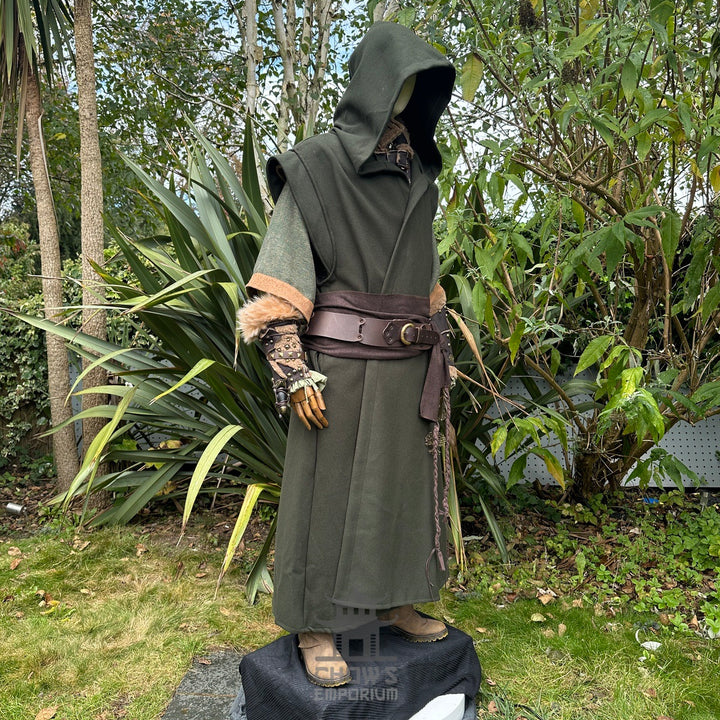 Medieval LARP outfit side view, featuring a green hooded robe, vambraces, belt, and sash. For Renaissance Faire and historical roleplay events.