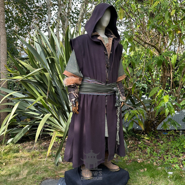 Medieval LARP outfit side view, featuring a brown hooded robe, waistcoat, vambraces, shirt, pants, belt, and 2 sashes. For Renaissance Faire and historical roleplay events.