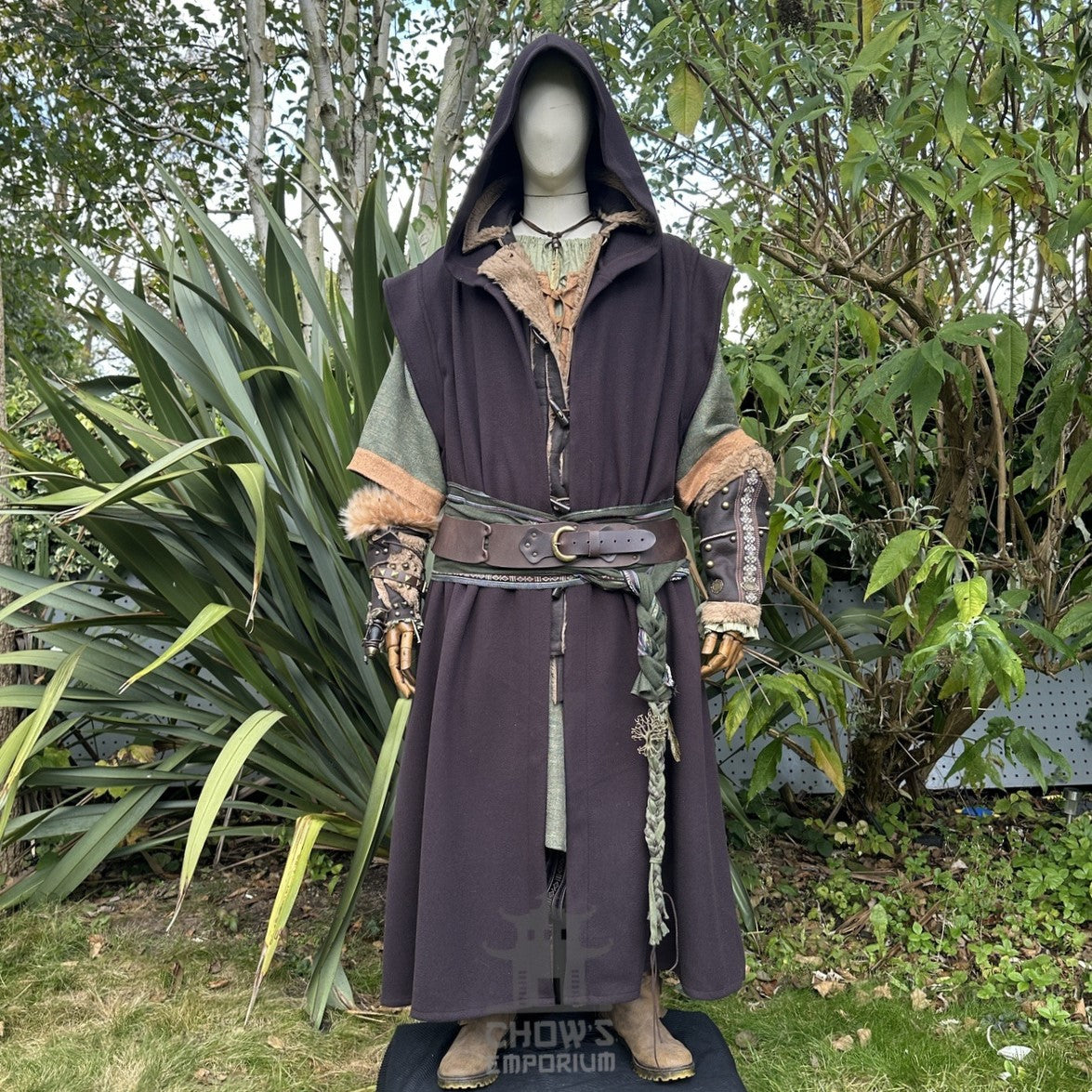 Mannequin in medieval hooded brown robe, green undergarment.