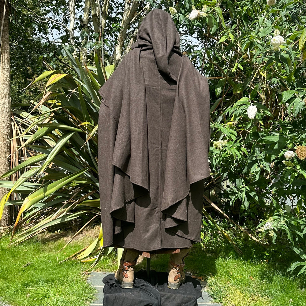 Medieval LARP costume back view featuring brown cloak, faux leather hood, arm wraps and sash. For Renaissance Faire and historical roleplay events.