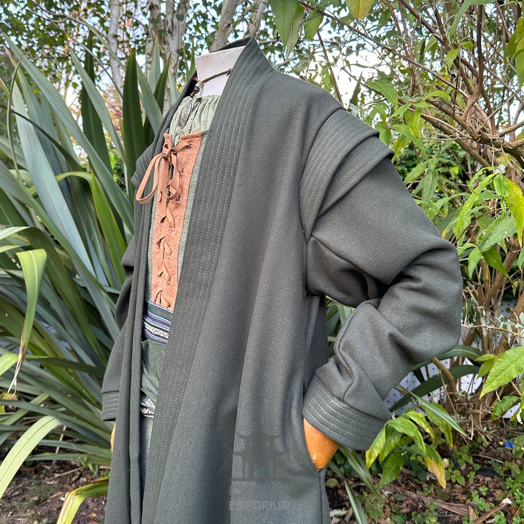 Forest wizard LARP outfit, green robe, brown tunic, and sash, natural setting.