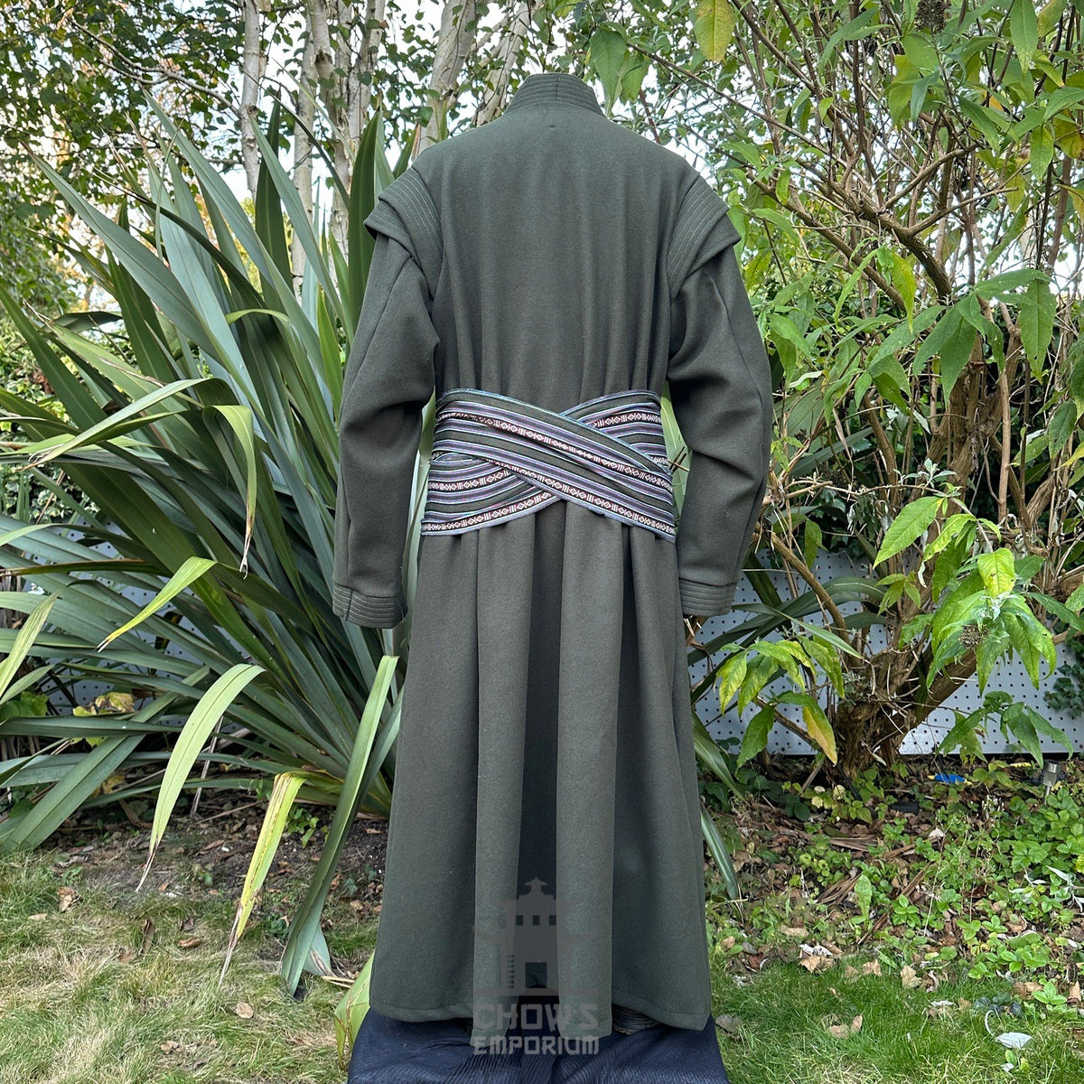 Back view of green medieval LARP robe with belt worn over the outer layer, authentic fantasy.