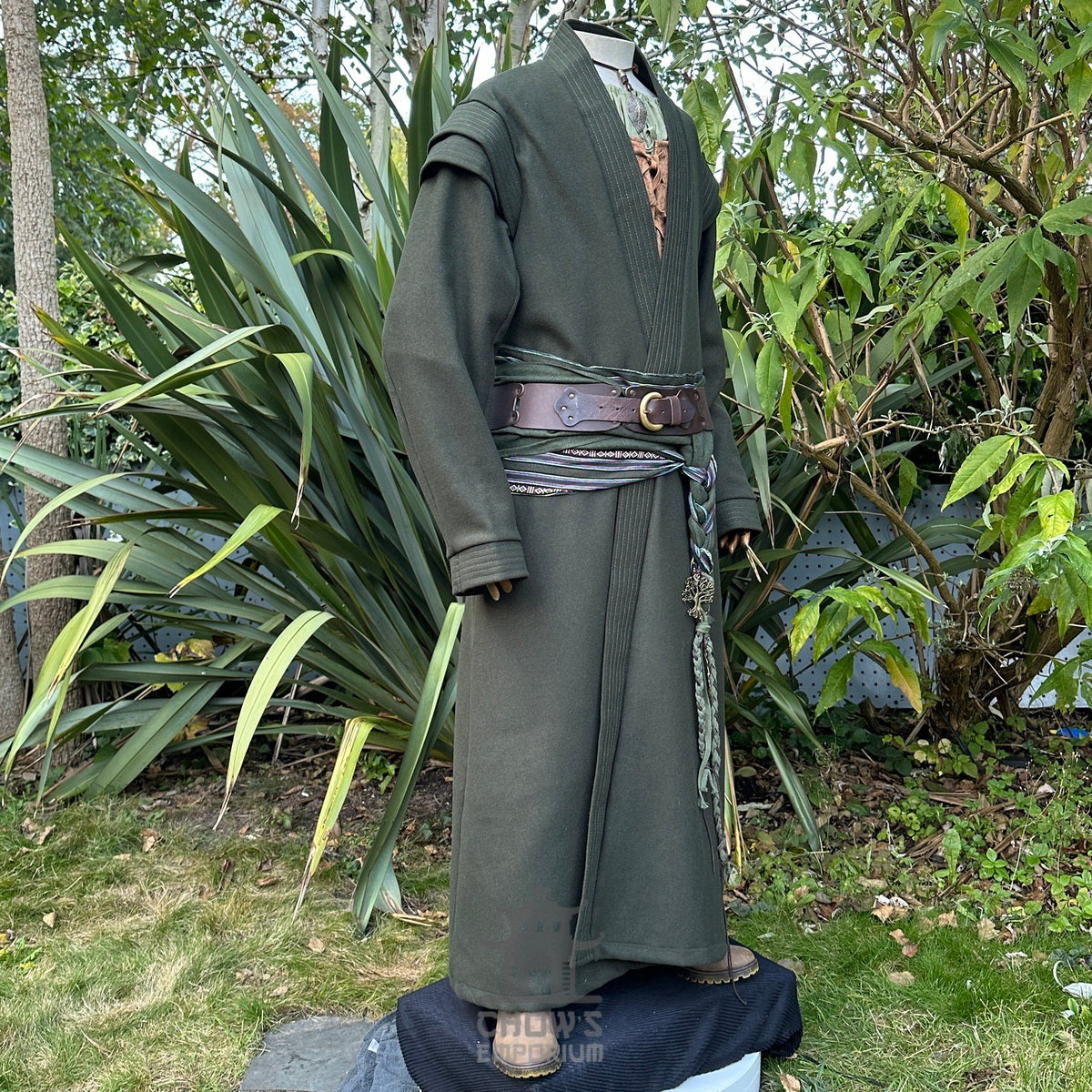 Profile view of green medieval LARP robe with braided belt detail.