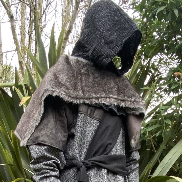 Medieval LARP outfit side view, featuring a grey wrap-around hood, and grey faux-fur mantle. For Renaissance Faire and historical roleplay events.
