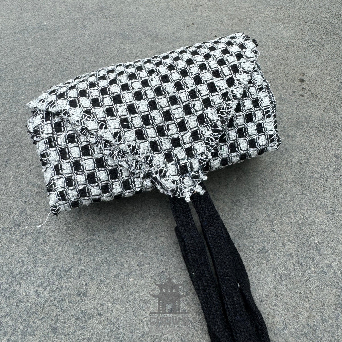 Black and white check LARP belt, buffalo leather material, top view.