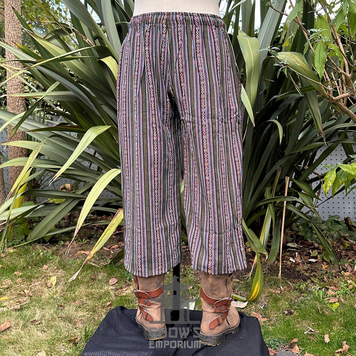 Back view of green fantasy trousers with relaxed straight-leg fit.