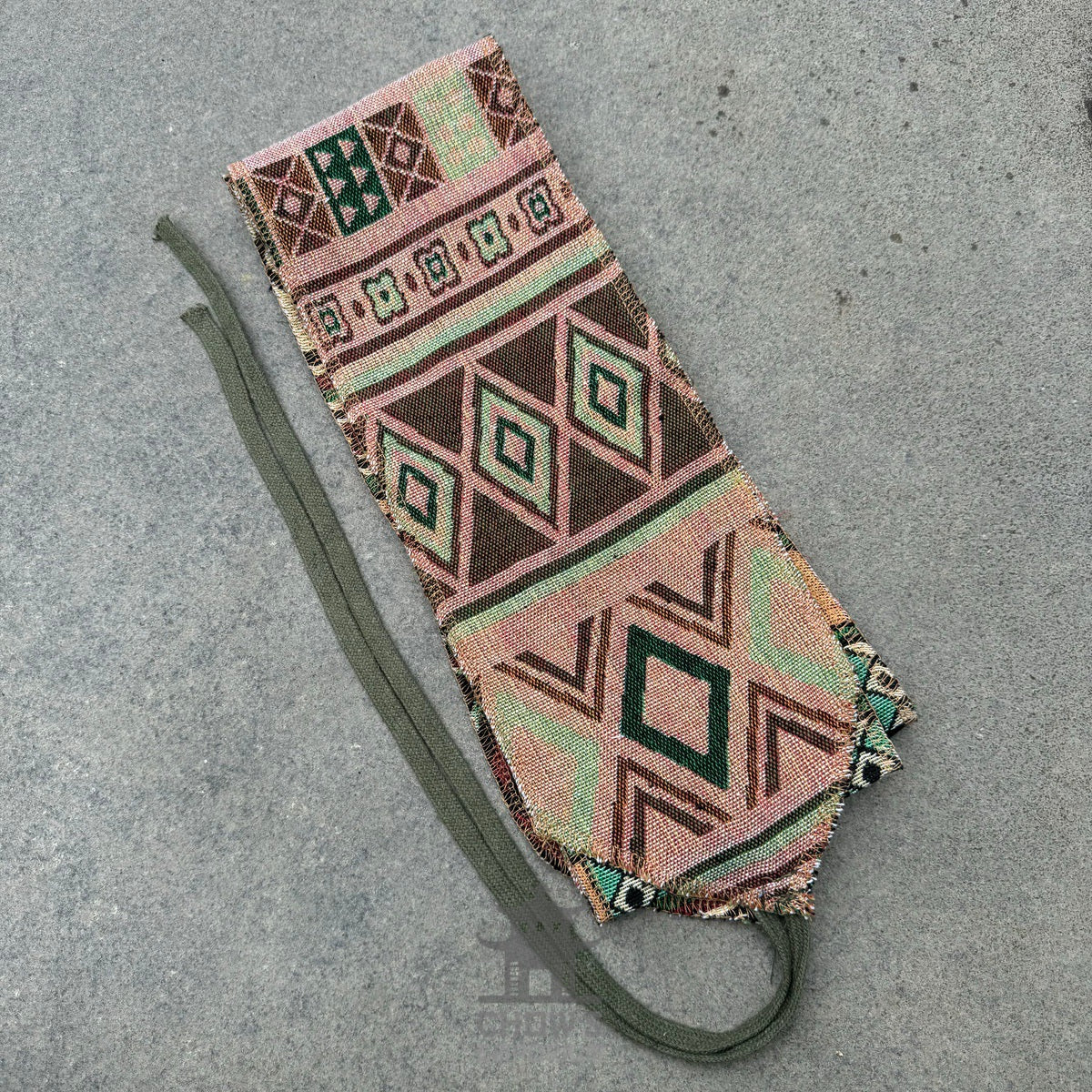 Green Aztec pattern pirate sash for medieval LARP, flat view on fabric.