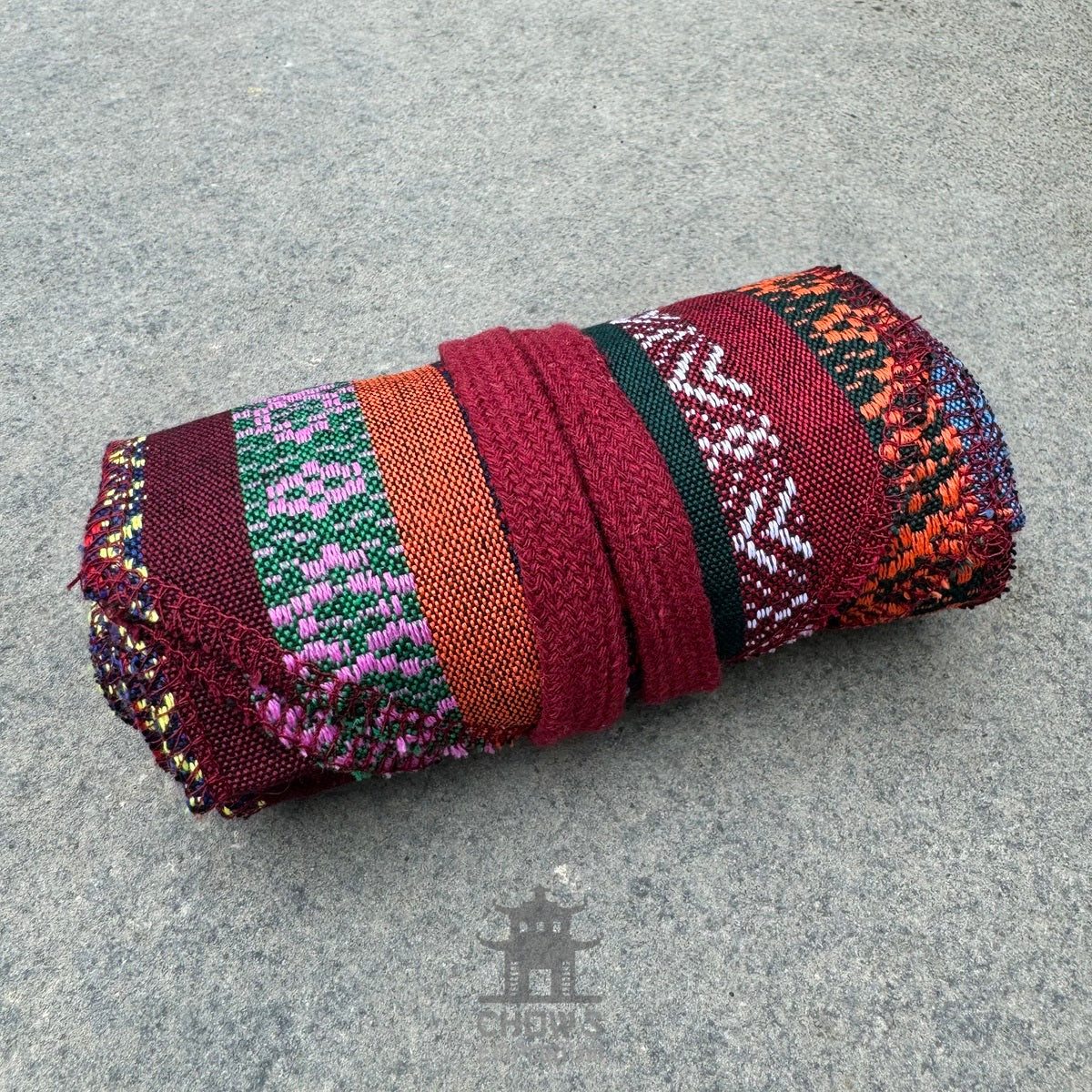 Multi-striped LARP pirate sash with rich burgundy and colorful patterns, side view.