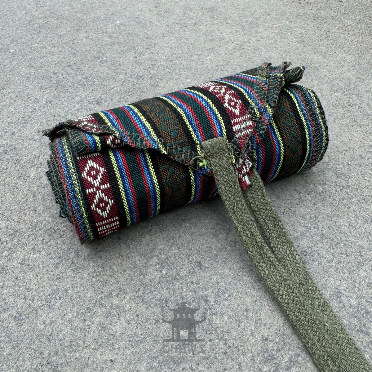 3 piece LARP outfit, green tunic, striped shirt and sash folded neatly.
