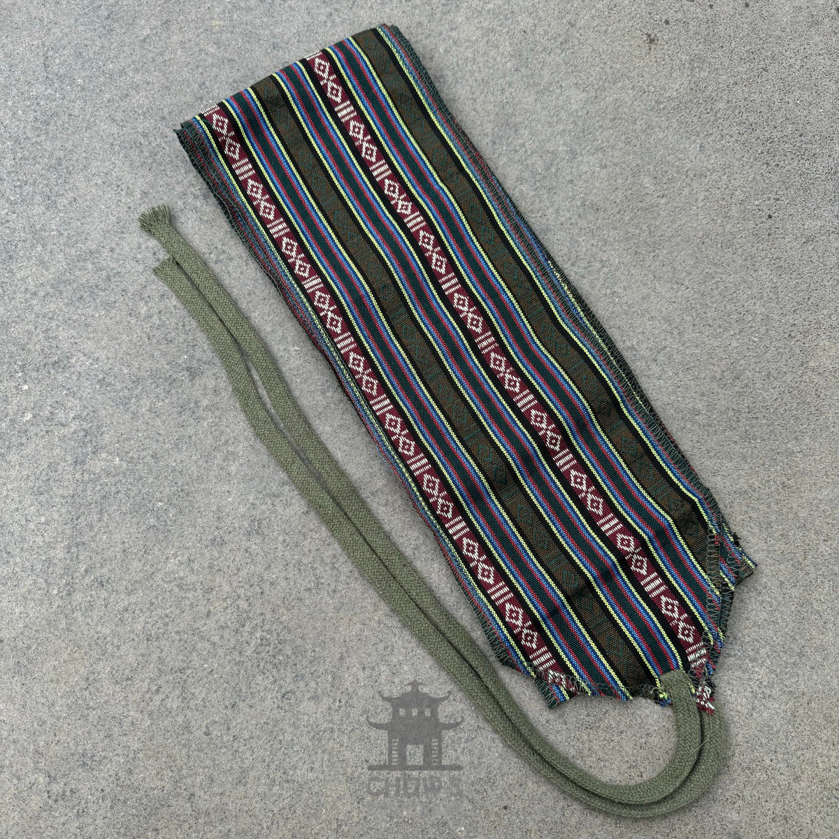 Green and striped sash with multicolor patterns for medieval LARP events.