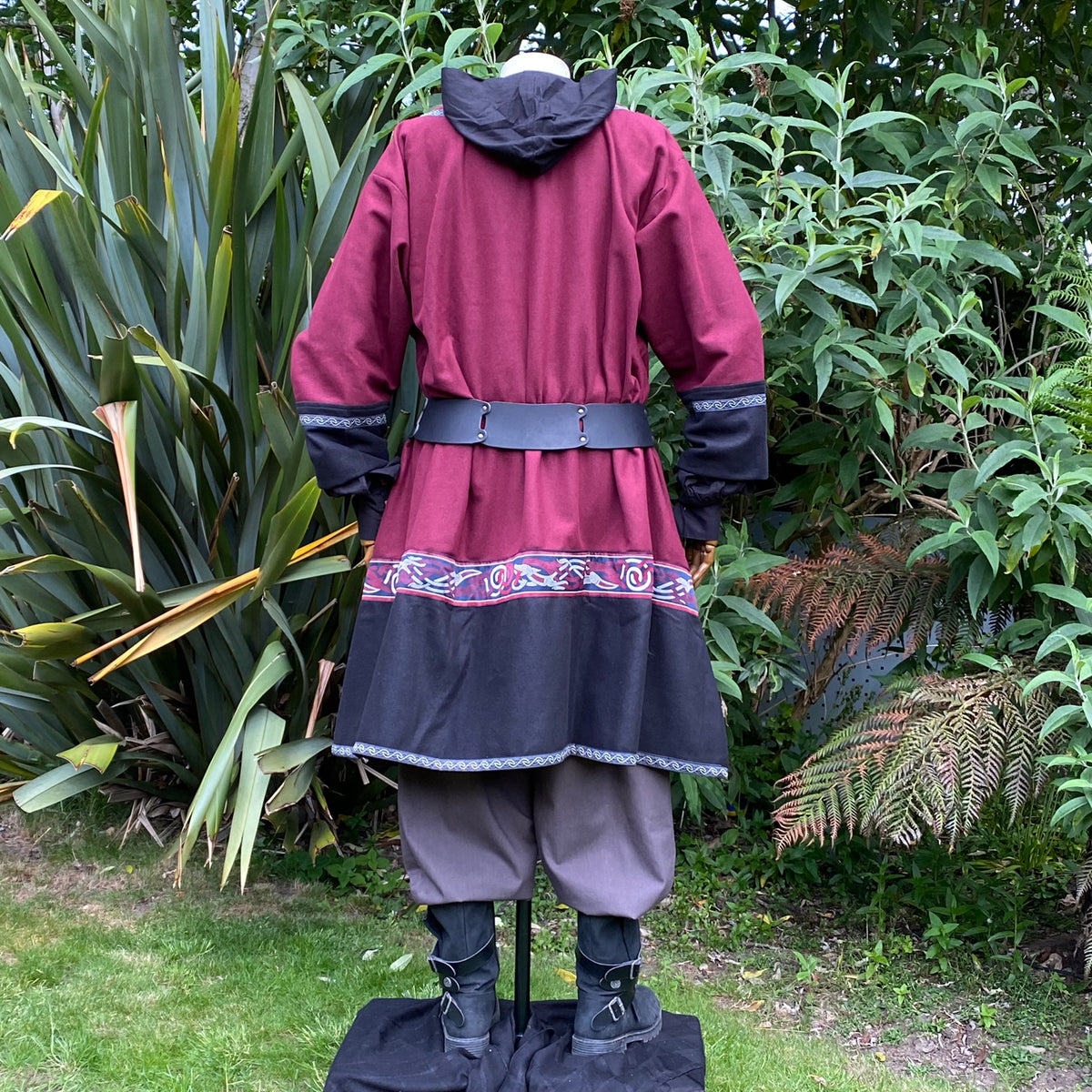 Rear view of LARP medieval tunic with hood, patterned hem and leather belt.