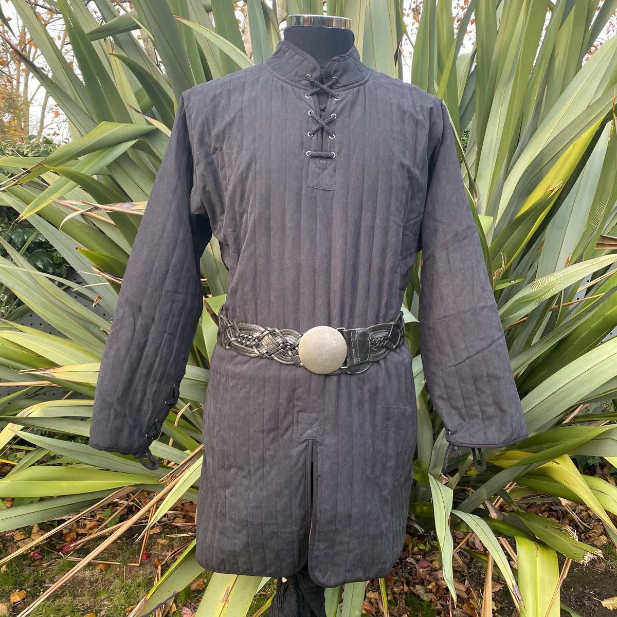 Black medieval gambeson with round buckle belt, front view.