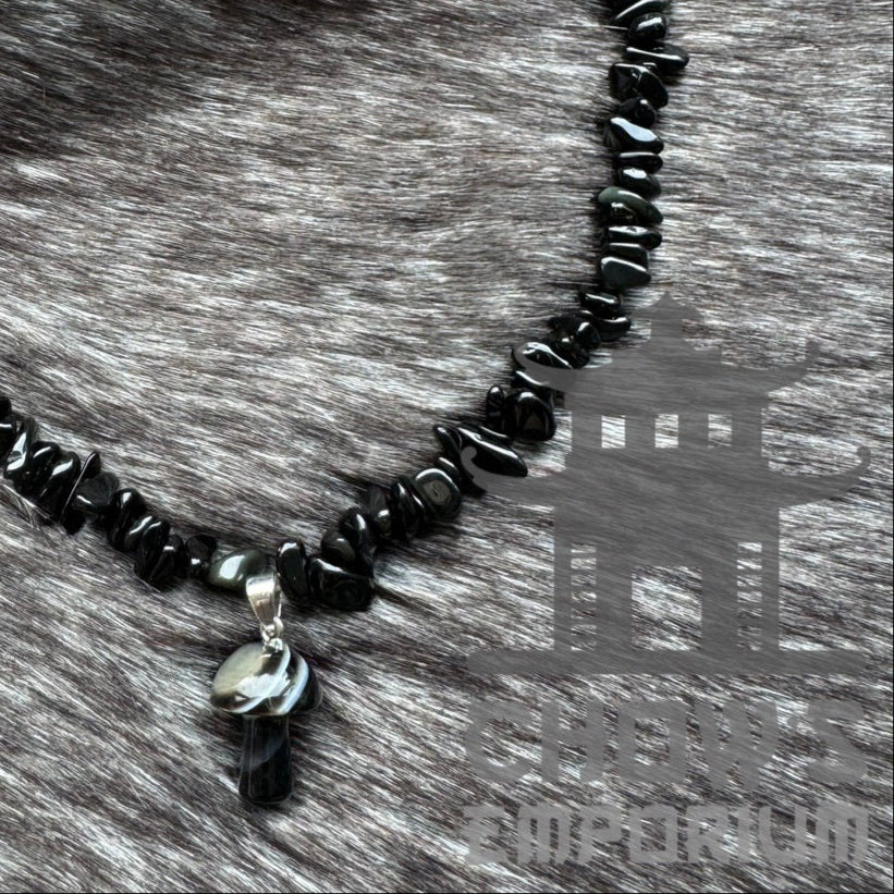 LARP black polished quartz stone necklace on fur background.