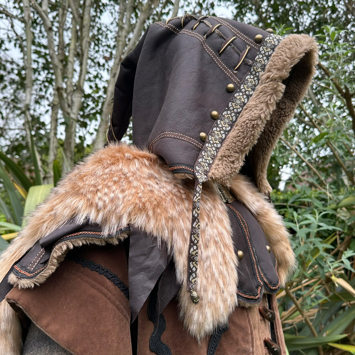 LARP hood side profile, brown faux leather with patterned trim and faux fur.