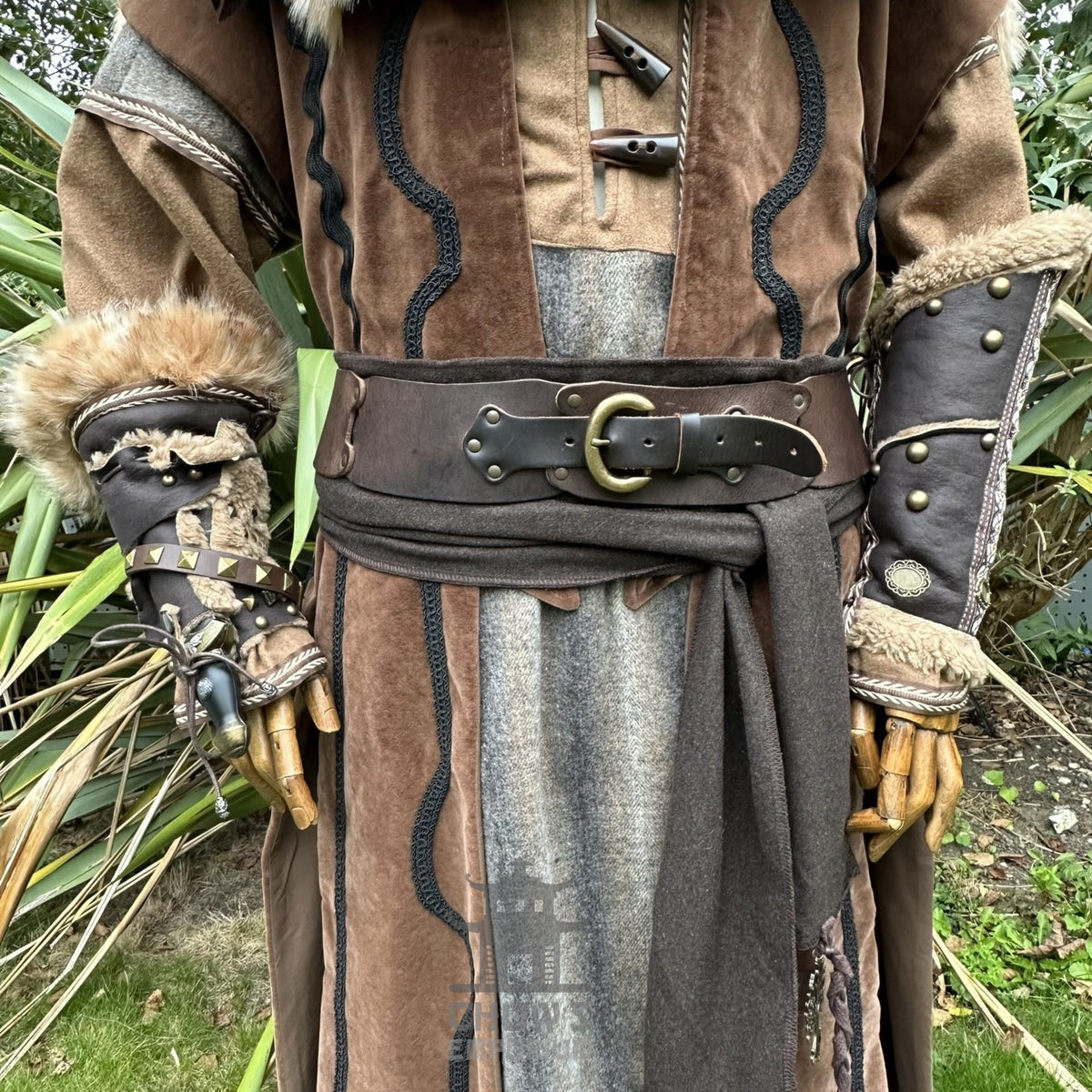 LARP costume close-up with fur-trimmed vambraces and layered brown robe.