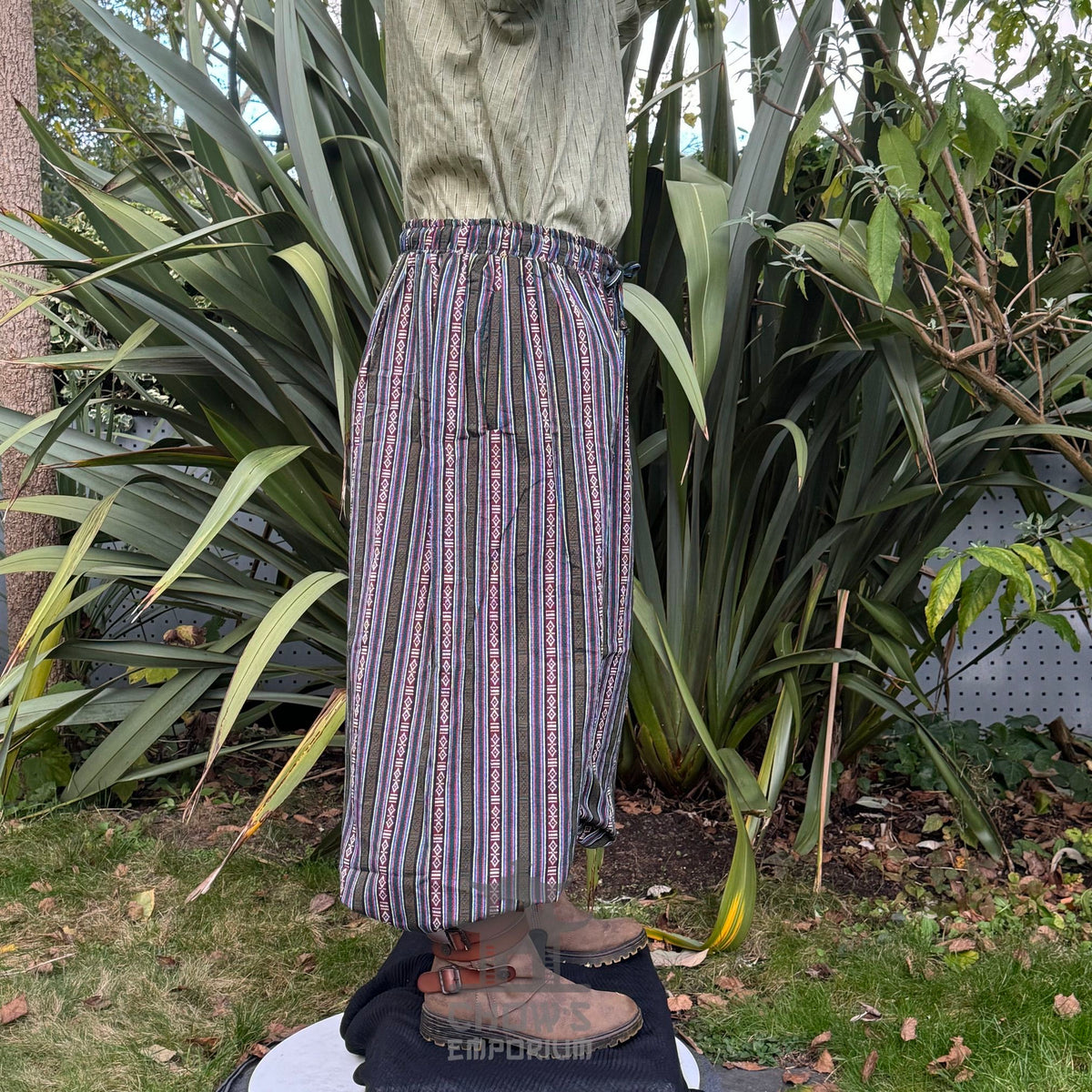 Striped medieval trousers and green tunic, side profile.