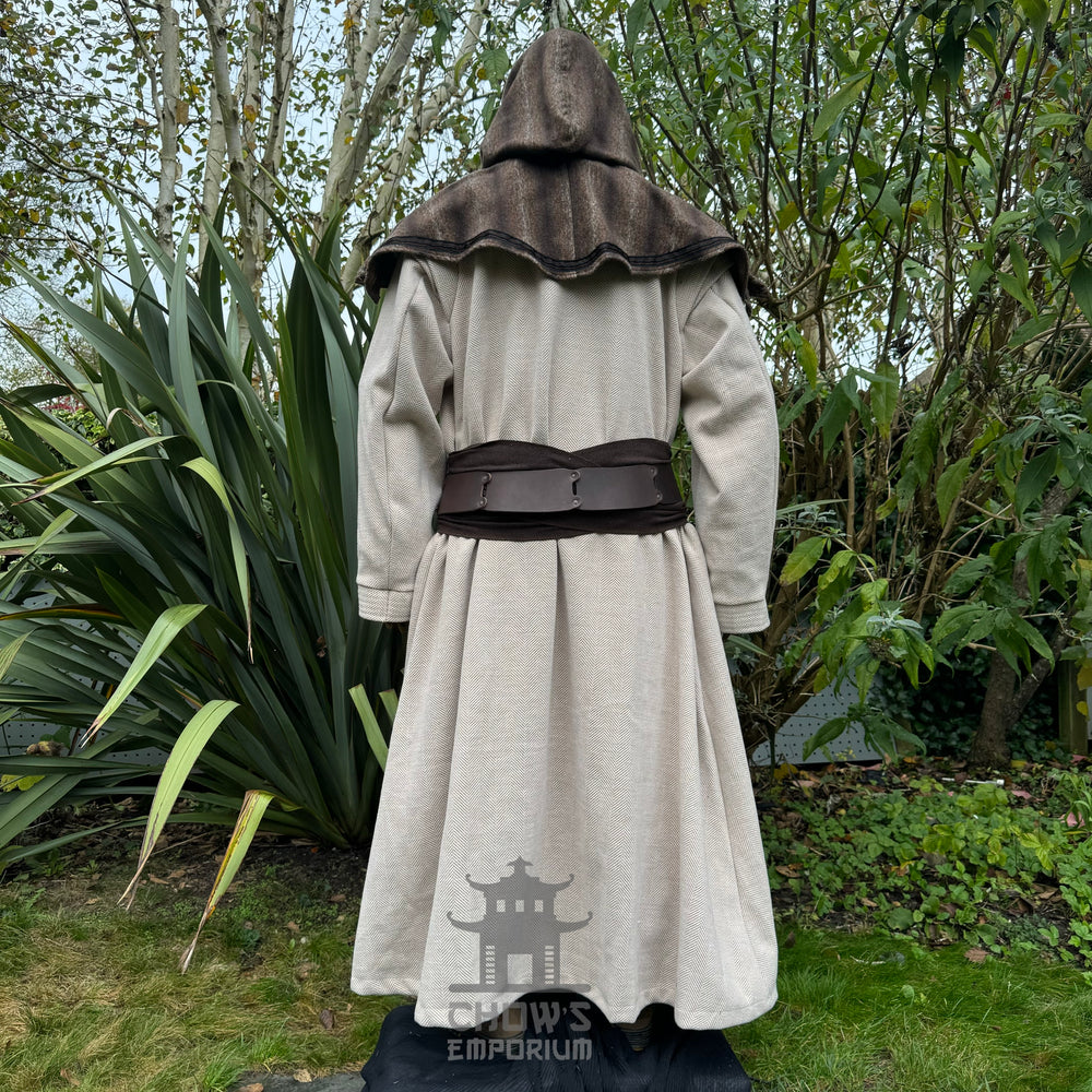 Medieval LARP costume back view, featuring a light brown full length robe, snood hood, and sash. For Renaissance Faire and historical roleplay events.