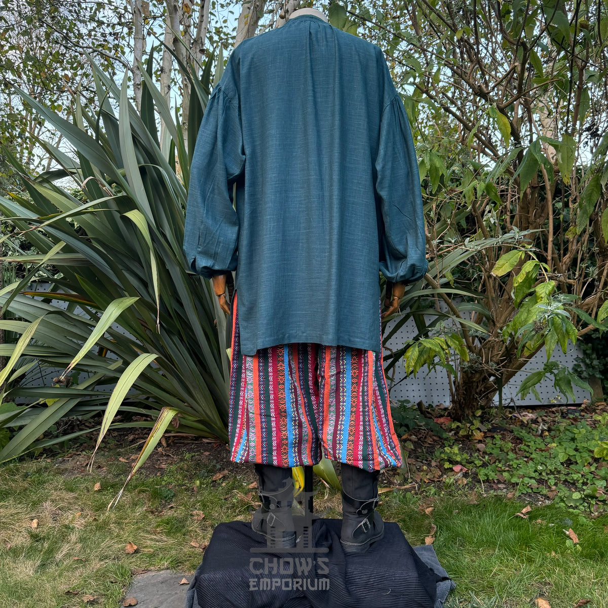 Back view of teal medieval shirt and striped pants for LARPing.