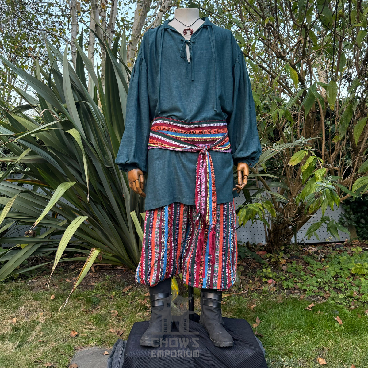Green medieval LARP robe set with blue shirt, red sash, striped trousers.