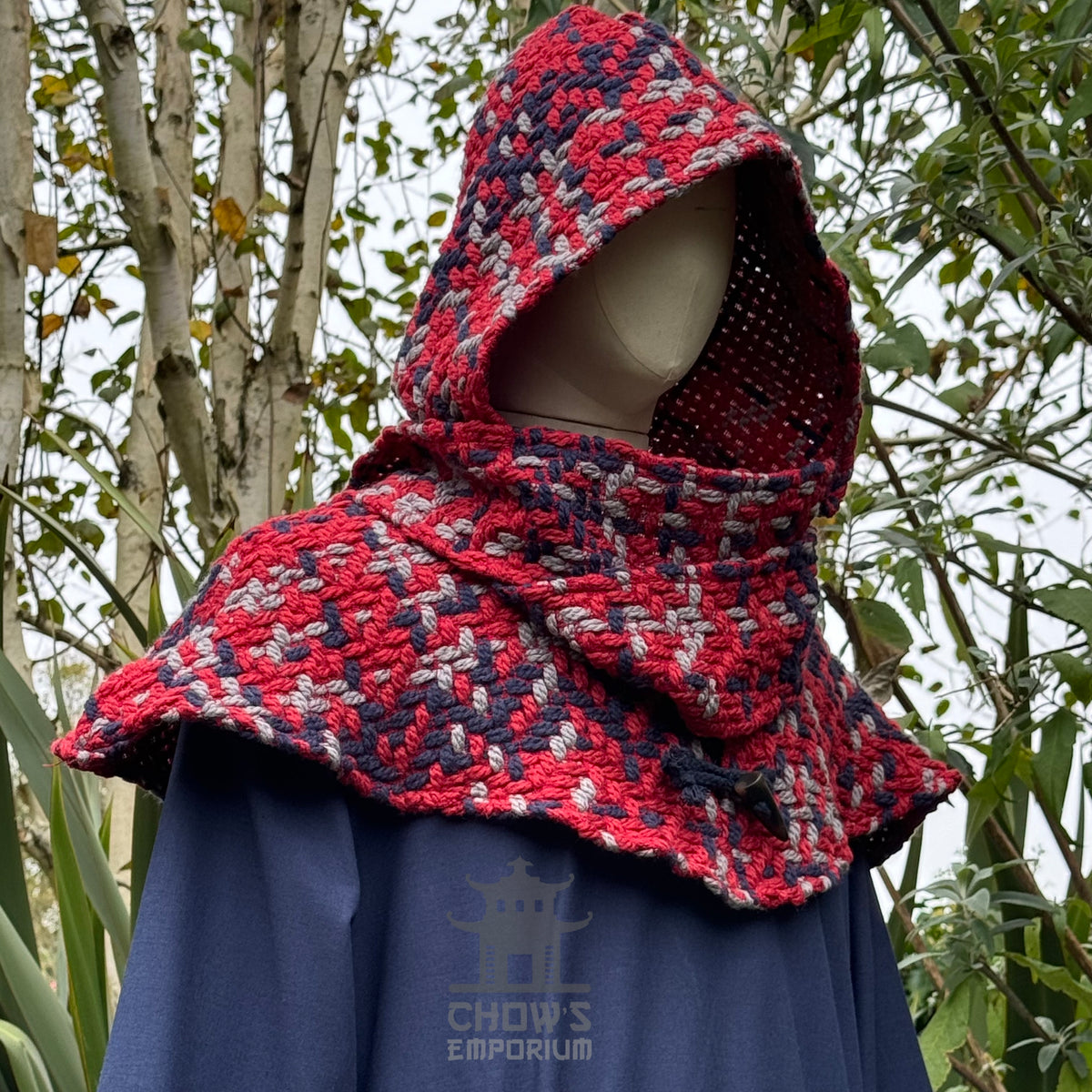 Red tricolour wool scarf hood for LARP, side view amid trees.