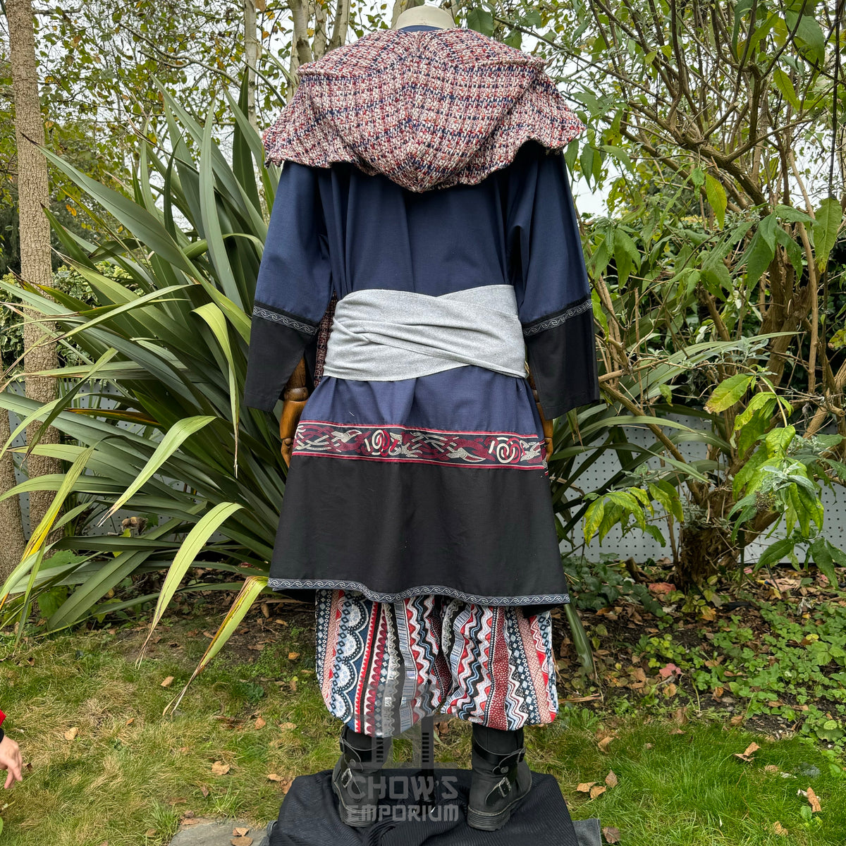 LARP outfit with blue tunic, red sash, patterned hood, and pants, rear view.