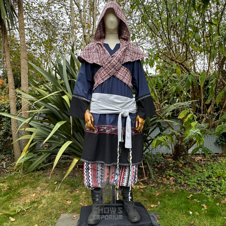 Medieval LARP outfit front view, featuring a blue and black tunic, patterned trousers, and sash. For Renaissance Faire and historical roleplay events.