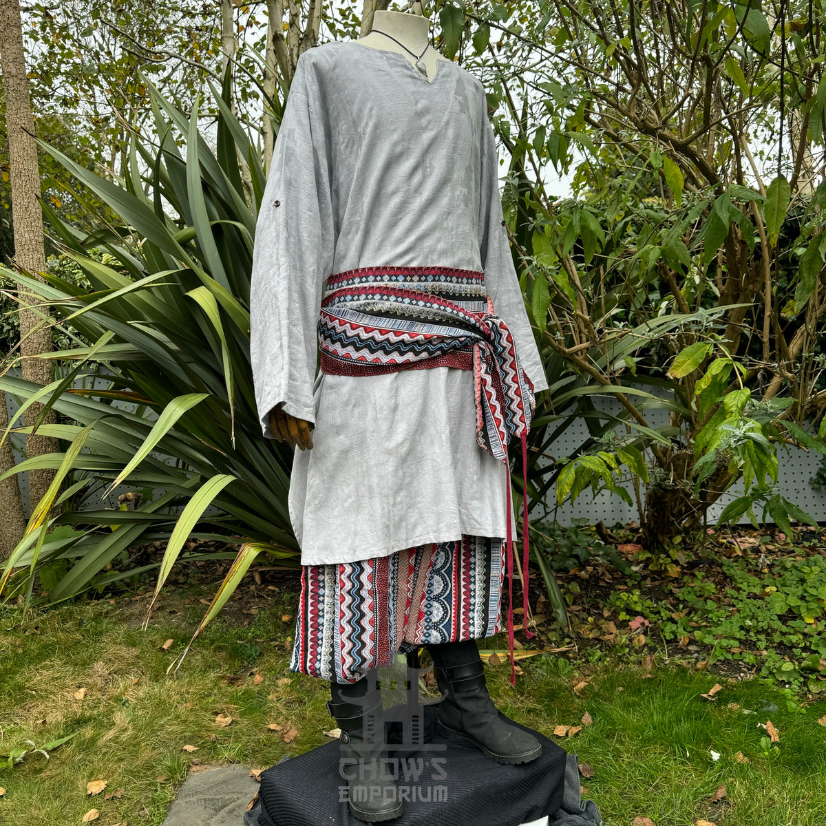 White textured medieval cotton tunic with patterned belt, side view, LARP attire.