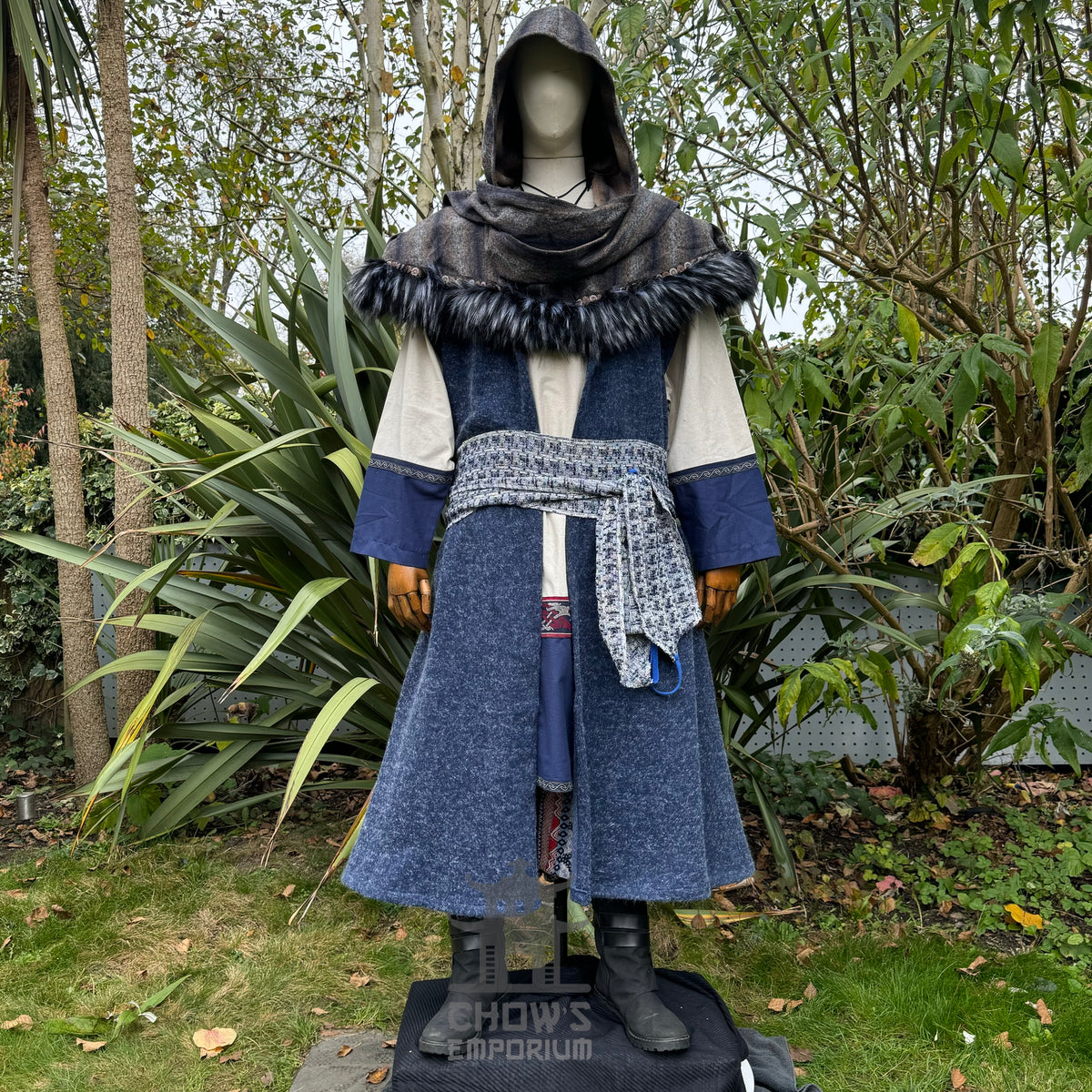 Medieval LARP outfit front view, featuring blue hooded waistcoat, wrap around hood, tunic and sash.
