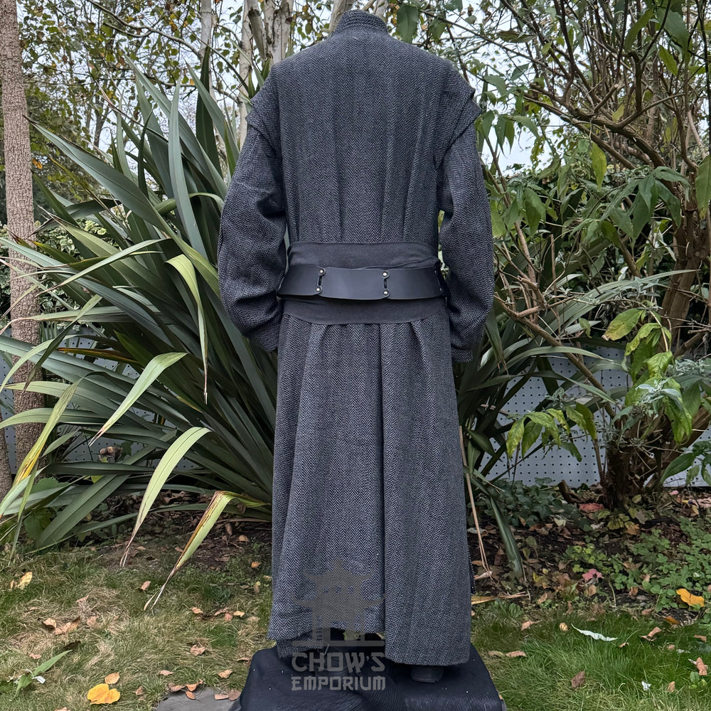 Medieval LARP costume back view, featuring a grey full length robe, black leather belt and grey sash. For Renaissance Faire and historical roleplay events.