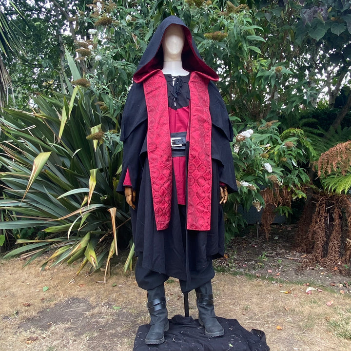 This Layered Woollen LARP Cloak in Black has multiple tiers of folded fabric to keep you warm and enhance your kit. The Viking Cloak has a Hood attached that, along with the LARP Cloak, keep you warm and dry. The Medieval Cape has a Red Lining to add flare to your LARP Character, Cosplay Event, or Ren Faire. 