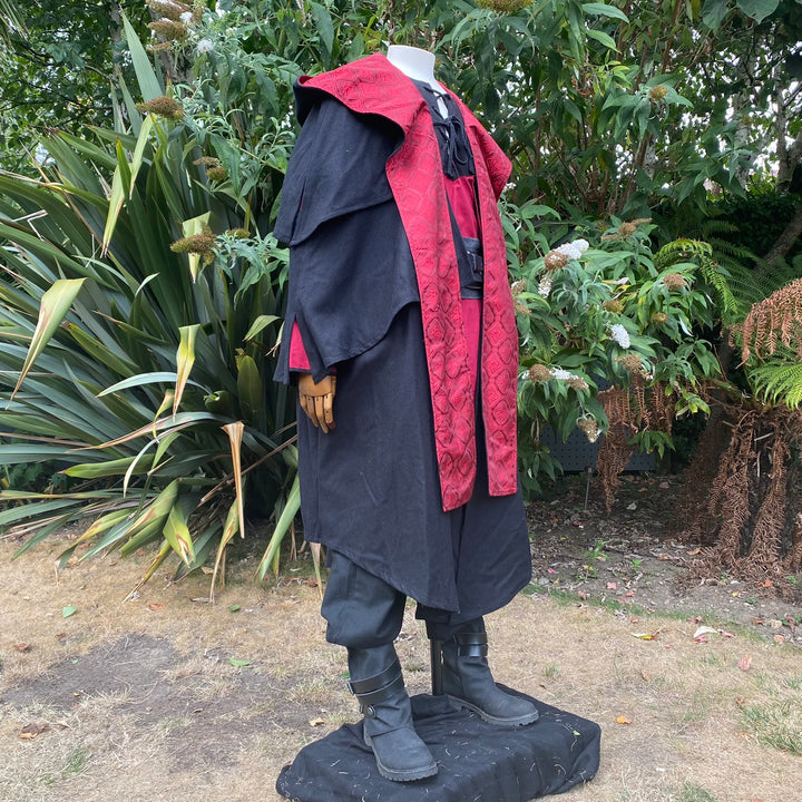 This Layered Woollen LARP Cloak in Black has multiple tiers of folded fabric to keep you warm and enhance your kit. The Viking Cloak has a Hood attached that, along with the LARP Cloak, keep you warm and dry. The Medieval Cape has a Red Lining to add flare to your LARP Character, Cosplay Event, or Ren Faire. 
