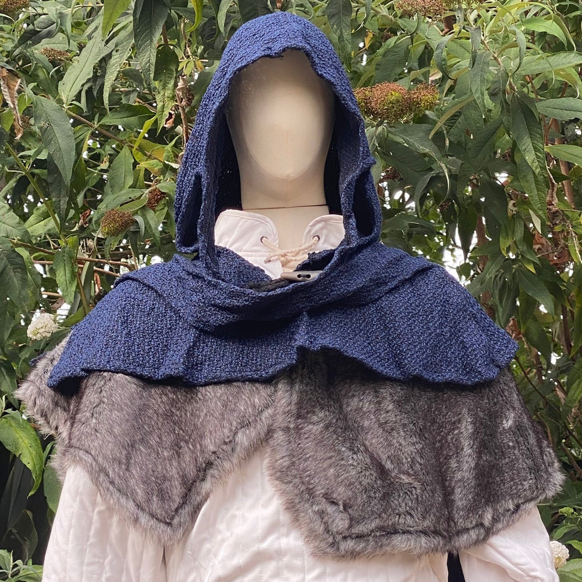 LARP outfit close-up, blue hood with grey faux-fur mantle.